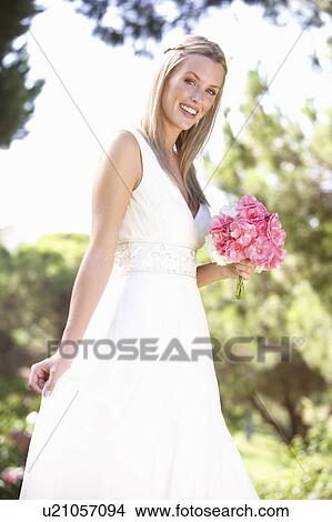 Bride Wearing Dress Holding Bouqet At Wedding View Large Photo Image Picture - Bride Wearing Dress Holding Bouqet At Wedding. Fotosearch
