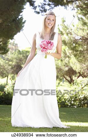 Bride Wearing Dress Holding Bouqet At Wedding View Large Photo Image Picture - Bride Wearing Dress Holding Bouqet At Wedding. Fotosearch