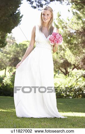 Bride Wearing Dress Holding Bouqet At Wedding View Large Photo Image Stock Image - Bride Wearing Dress Holding Bouqet At Wedding. Fotosearch