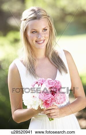 Bride Wearing Dress Holding Bouqet At Wedding View Large Photo Image Stock Image - Bride Wearing Dress Holding Bouqet At Wedding. Fotosearch