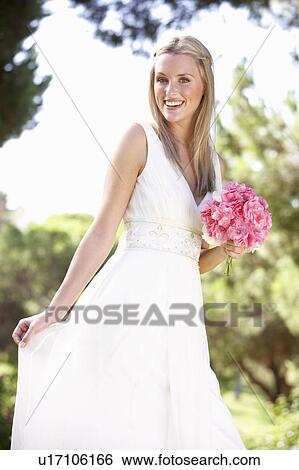 Bride Wearing Dress Holding Bouqet At Wedding View Large Photo Image Stock Photograph - Bride Wearing Dress Holding Bouqet At Wedding. Fotosearch