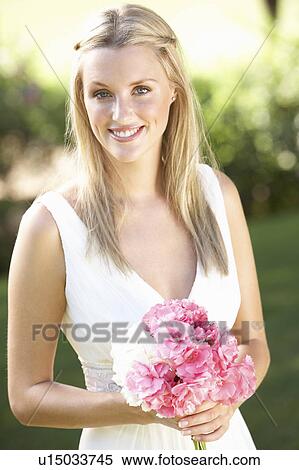 Bride Wearing Dress Holding Bouqet At Wedding View Large Photo Image Stock Photography - Bride Wearing Dress Holding Bouqet At Wedding. Fotosearch