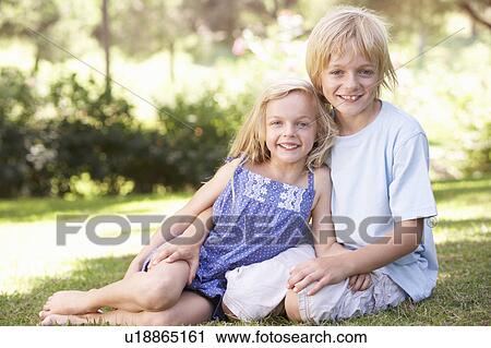Brother and sister pose in a park View Large Photo Image Stock Image - Brother and sister pose in a park. Fotosearch