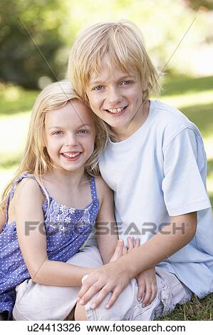 Brother and sister pose in a park View Large Photo Image Stock Photograph - Brother and sister pose in a park. Fotosearch