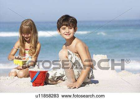 Children Building Sandcastles On Beach Holiday View Large Photo Image Stock Image - Children Building Sandcastles On Beach Holiday. Fotosearch