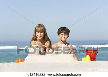 Children Building Sandcastles On Beach Holiday View Large Photo Image Stock Image - Children Building Sandcastles On Beach Holiday. Fotosearch