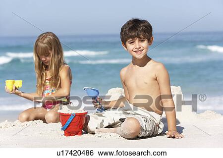 Children Building Sandcastles On Beach Holiday View Large Photo Image Stock Photograph - Children Building Sandcastles On Beach Holiday. Fotosearch