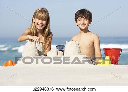 Children Building Sandcastles On Beach Holiday View Large Photo Image Stock Photograph - Children Building Sandcastles On Beach Holiday. Fotosearch