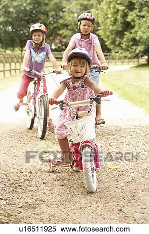 Stock Photography - Children In Countryside Wearing Safety Helmets. Fotosearch