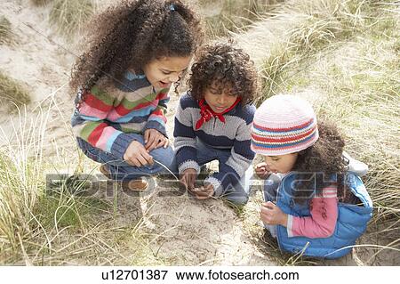 Children Playing In Dunes On Winter Beach View Large Photo Image Stock Photo - Children Playing In Dunes On Winter Beach. Fotosearch