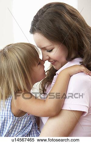 Stock Photography - Close Up Of Affectionate Mother And Daughter At Home. Fotosearch
