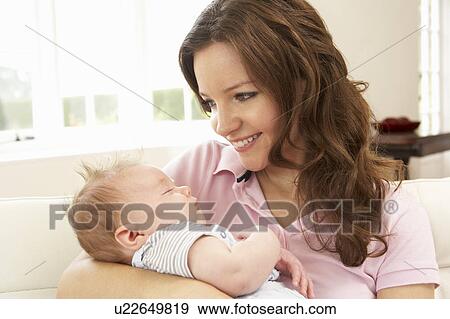 Close Up Of Affectionate Mother Cuddling Baby Boy At Home View Large Photo Image Stock Photo - Close Up Of Affectionate Mother Cuddling Baby Boy At Home. Fotosearch