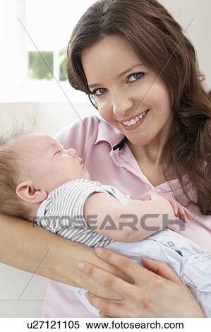 Close Up Of Affectionate Mother Cuddling Baby Boy At Home View Large Photo Image Stock Photography - Close Up Of Affectionate Mother Cuddling Baby Boy At Home. Fotosearch