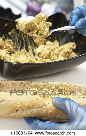 Picture - Close Up Of Hands Preparing Sandwich In Café. Fotosearch