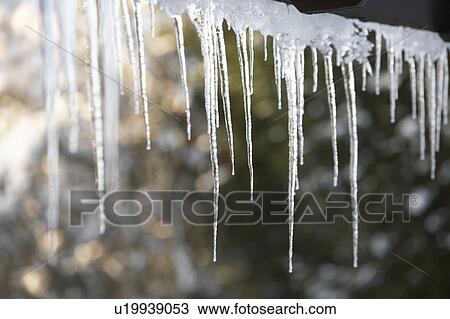 Stock Image - Close Up Of Icicles Hanging From Roof. Fotosearch