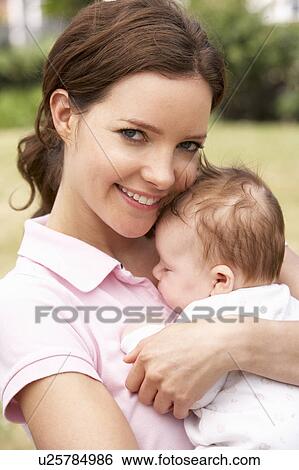 Close Up Of Mother Cuddling Newborn Baby Boy Outdoors At Home View Large Photo Image Stock Photograph - Close Up Of Mother Cuddling Newborn Baby Boy Outdoors At Home. Fotosearch