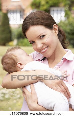 Close Up Of Mother Cuddling Newborn Baby Boy Outdoors At Home View Large Photo Image Stock Photography - Close Up Of Mother Cuddling Newborn Baby Boy Outdoors At Home. Fotosearch