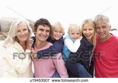 Stock Photo - Close Up Of Three Generation Family On Winter Beach. Fotosearch