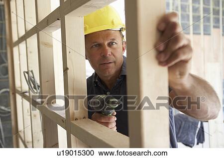 Construction Worker Building Timber Frame In New Home View Large Photo Image Stock Image - Construction Worker Building Timber Frame In New Home. Fotosearch