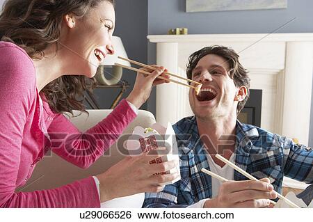 Couple Enjoying Chinese Takeaway Meal At Home View Large Photo Image Stock Photograph - Couple Enjoying Chinese Takeaway Meal At Home. Fotosearch