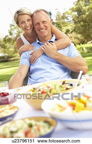 Couple Enjoying Meal In Garden View Large Photo Image Stock Image - Couple Enjoying Meal In Garden. Fotosearch
