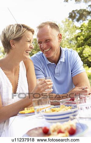 Couple Enjoying Meal In Garden View Large Photo Image Stock Photo - Couple Enjoying Meal In Garden. Fotosearch