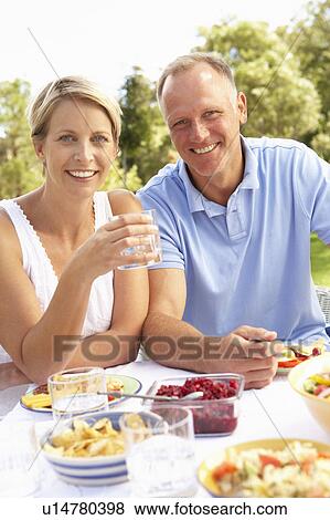 Couple Enjoying Meal In Garden View Large Photo Image Stock Photo - Couple Enjoying Meal In Garden. Fotosearch