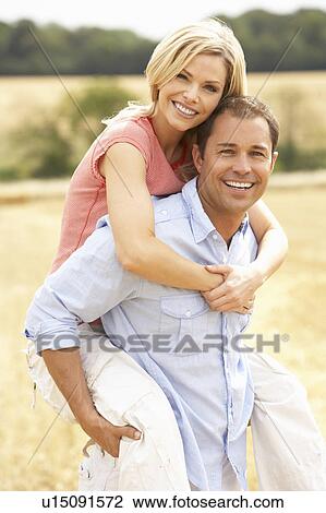 Couple Having Piggyback In Summer Harvested Field View Large Photo Image Stock Image - Couple Having Piggyback In Summer Harvested Field. Fotosearch
