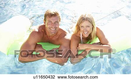 Couple Outside Relaxing In Swimming Pool View Large Photo Image Stock Image - Couple Outside Relaxing In Swimming Pool. Fotosearch