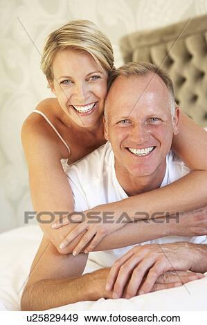 Couple Relaxing In Bedroom View Large Photo Image Stock Photo - Couple Relaxing In Bedroom. Fotosearch