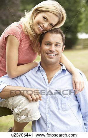 Couple Relaxing In Countryside Sitting On Fence View Large Photo Image Stock Image - Couple Relaxing In Countryside Sitting On Fence. Fotosearch