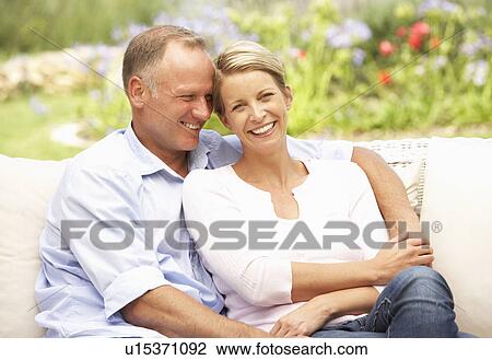 Couple Relaxing In Garden View Large Photo Image Stock Image - Couple Relaxing In Garden. Fotosearch