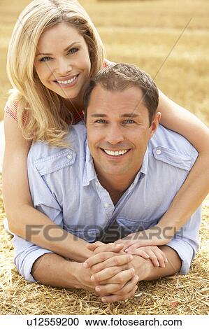 Couple Relaxing In Summer Harvested Field View Large Photo Image Stock Image - Couple Relaxing In Summer Harvested Field. Fotosearch