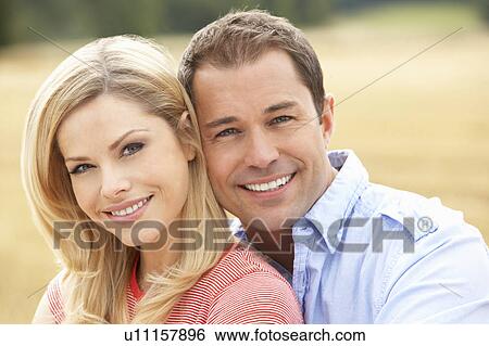 Couple Sitting On Straw Bales In Harvested Field View Large Photo Image Stock Photograph - Couple Sitting On Straw Bales In Harvested Field. Fotosearch