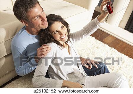 Couple Taking Photograph On Digital Camera At Home View Large Photo Image Stock Image - Couple Taking Photograph On Digital Camera At Home . Fotosearch
