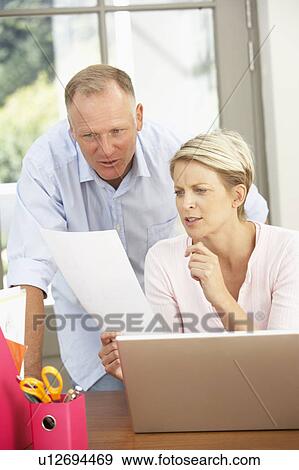 Couple Using Laptop At Home View Large Photo Image Stock Photo - Couple Using Laptop At Home. Fotosearch