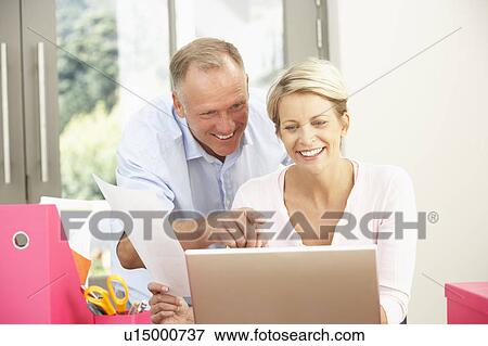 Couple Using Laptop At Home View Large Photo Image Stock Photo - Couple Using Laptop At Home. Fotosearch