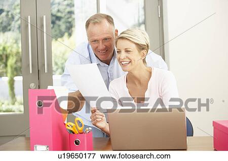Couple Using Laptop At Home View Large Photo Image Stock Photo - Couple Using Laptop At Home. Fotosearch