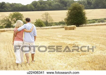 Couple Walking Together Through Summer Harvested Field View Large Photo Image Stock Image - Couple Walking Together Through Summer Harvested Field. Fotosearch