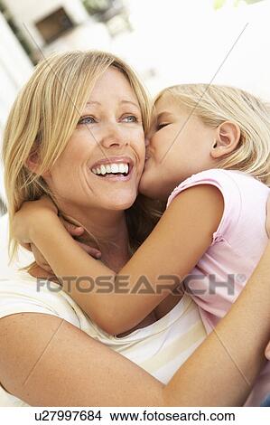 Daughter Giving Mother Kiss Relaxing On Sofa View Large Photo Image Picture - Daughter Giving Mother Kiss Relaxing On Sofa. Fotosearch