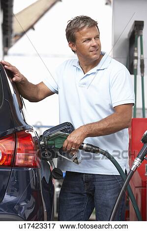 Stock Photo - Detail Of Male Motorist Filling Car With Diesel At Petrol Station. Fotosearch