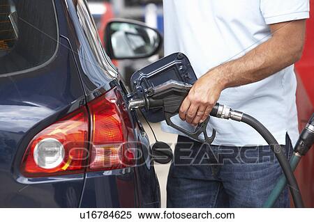 Detail Of Male Motorist Filling Car With Diesel At Petrol Station View Large Photo Image Stock Photography - Detail Of Male Motorist Filling Car With Diesel At Petrol Station. Fotosearch