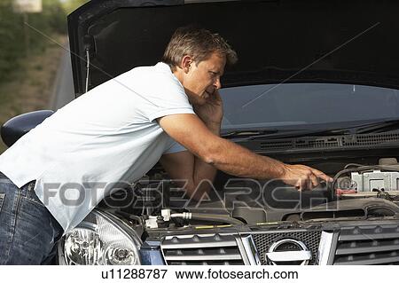 Stock Photo - Driver Broken Down On Country Road. Fotosearch