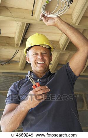 Electrician Working On Wiring In New Home View Large Photo Image Stock Photography - Electrician Working On Wiring In New Home. Fotosearch