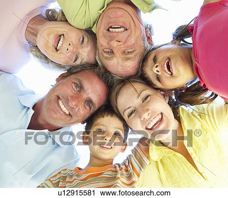Stock Image - Extended Family Group Looking Down Into Camera. Fotosearch