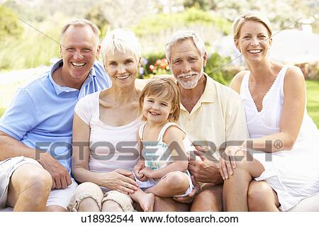 Extended Family Relaxing In Garden View Large Photo Image Picture - Extended Family Relaxing In Garden. Fotosearch