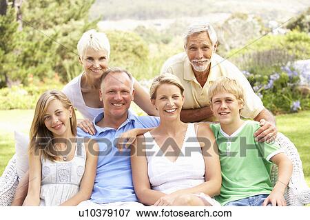 Stock Photo - Extended Family Relaxing In Garden. Fotosearch