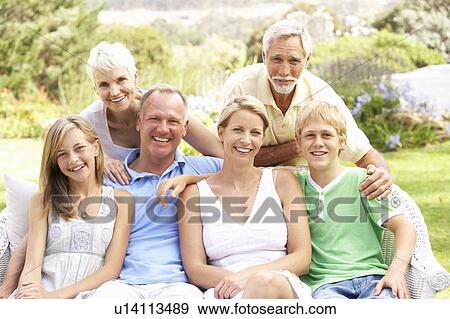 Extended Family Relaxing In Garden View Large Photo Image Stock Photo - Extended Family Relaxing In Garden. Fotosearch