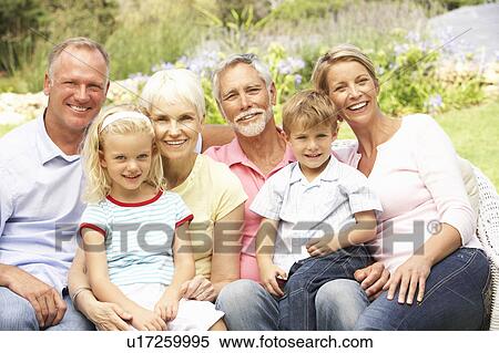 Stock Photography - Extended Family Relaxing In Garden. Fotosearch