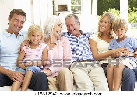 Extended Family Relaxing Together On Sofa View Large Photo Image Stock Image - Extended Family Relaxing Together On Sofa. Fotosearch
